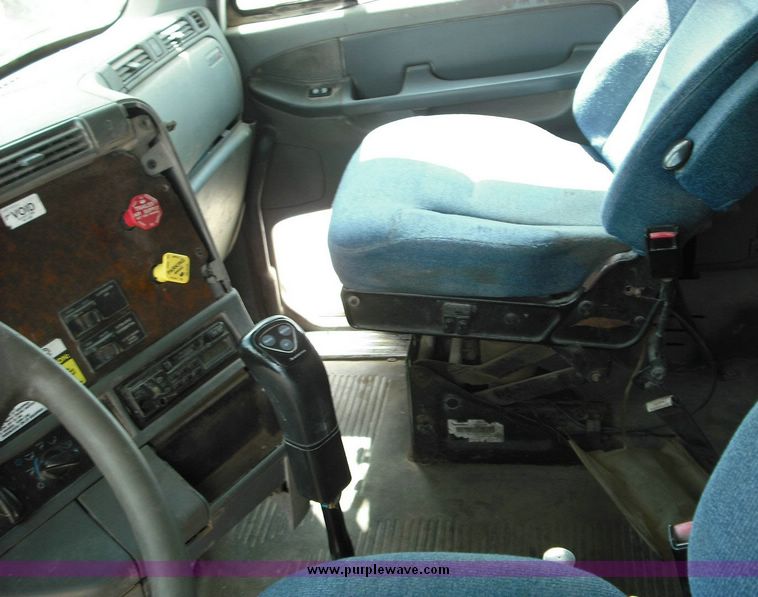 image for item 2296 2000 Freightliner Conventional FLC120 truck with Workhorse steel half round dump bed