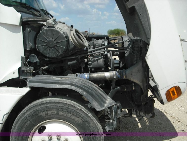 image for item 2296 2000 Freightliner Conventional FLC120 truck with Workhorse steel half round dump bed