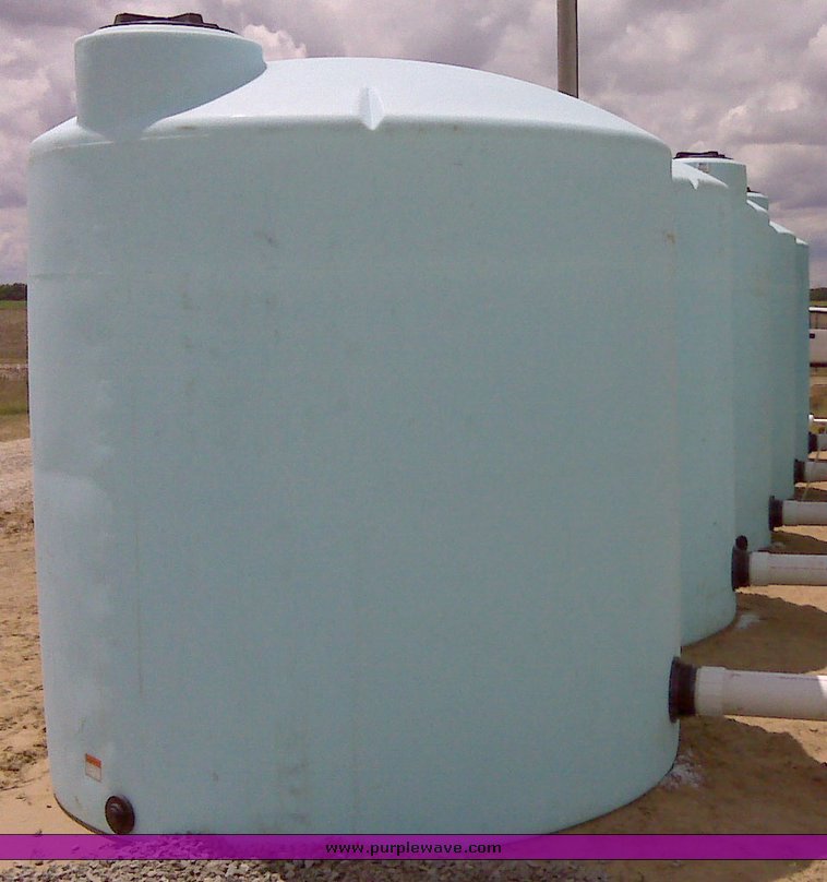 image for item 1301 (2) 3,000 gallon 5yr vertical plastic tanks