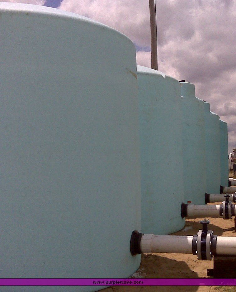image for item 1302 (3) 3,000 gallon 5yr vertical plastic tanks
