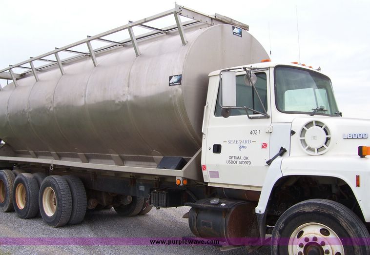 image for item 1107 1996 Ford LNT8000F triple axle food delivery truck with warren six bin feed body