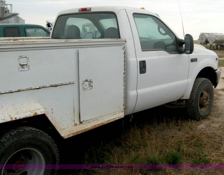 image for item 8719 1999 Ford F350 super duty pickup truck with utility bed