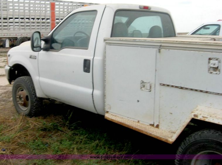 image for item 8719 1999 Ford F350 super duty pickup truck with utility bed