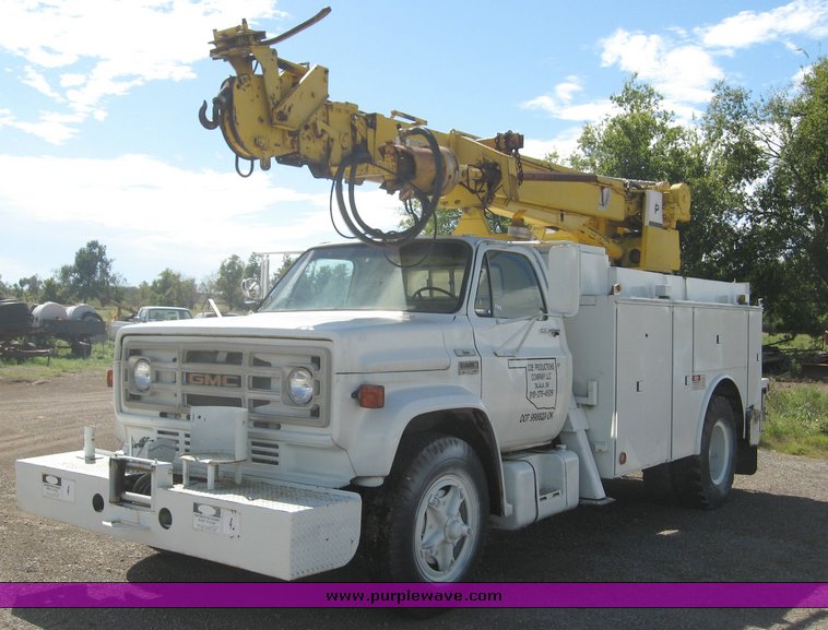 image for item 6722 1979 GMC truck with utility bed and Pitman Polecat 1500 boom arm with hydraulic driven auger and 18" bit