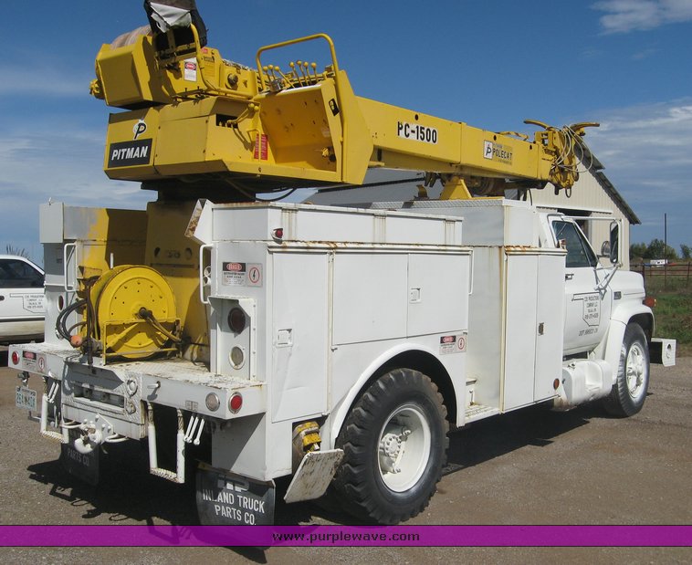 image for item 6722 1979 GMC truck with utility bed and Pitman Polecat 1500 boom arm with hydraulic driven auger and 18" bit