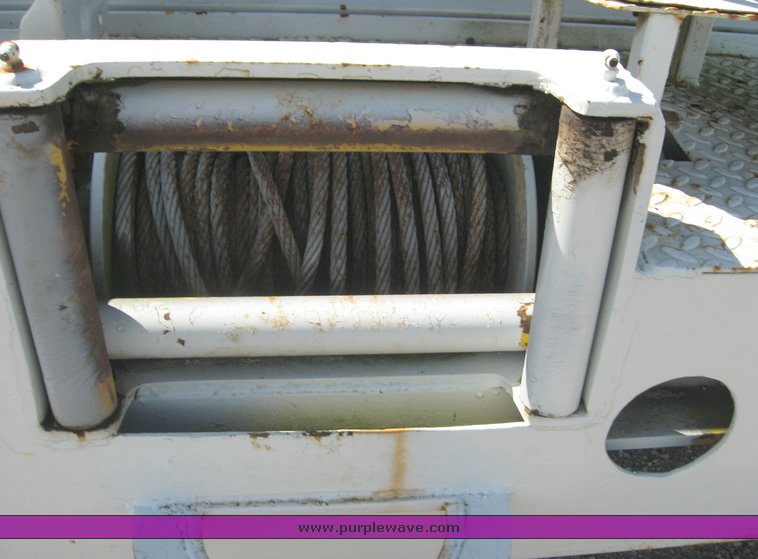 image for item 6722 1979 GMC truck with utility bed and Pitman Polecat 1500 boom arm with hydraulic driven auger and 18" bit