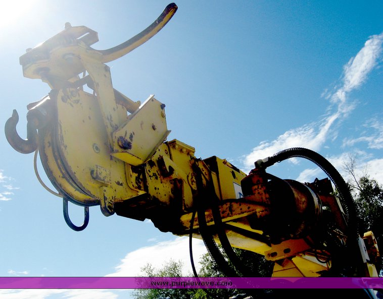 image for item 6722 1979 GMC truck with utility bed and Pitman Polecat 1500 boom arm with hydraulic driven auger and 18" bit