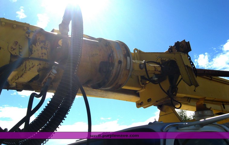 image for item 6722 1979 GMC truck with utility bed and Pitman Polecat 1500 boom arm with hydraulic driven auger and 18" bit