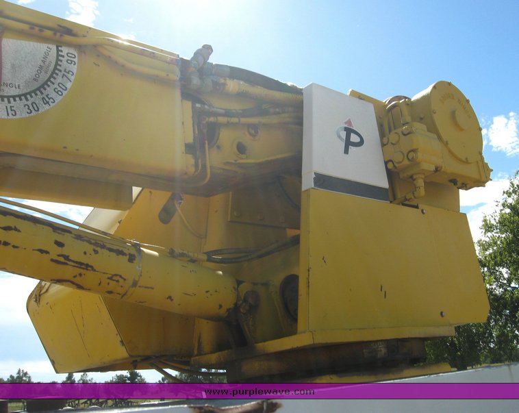 image for item 6722 1979 GMC truck with utility bed and Pitman Polecat 1500 boom arm with hydraulic driven auger and 18" bit