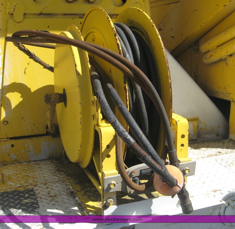 image for item 6722 1979 GMC truck with utility bed and Pitman Polecat 1500 boom arm with hydraulic driven auger and 18" bit