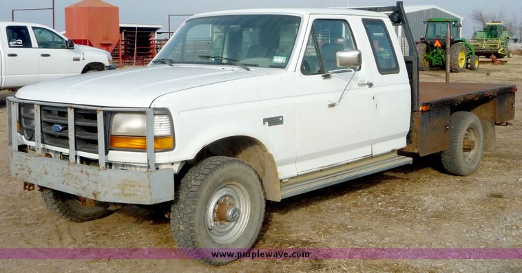 image for item 5124 1992 Ford F-250 extended cab pickup with flatbed and bale spike