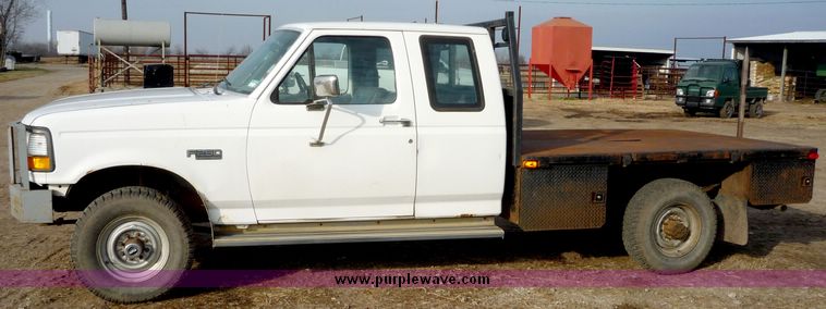 image for item 5124 1992 Ford F-250 extended cab pickup with flatbed and bale spike