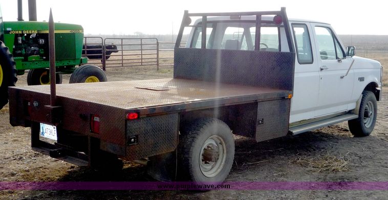 image for item 5124 1992 Ford F-250 extended cab pickup with flatbed and bale spike