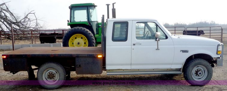 image for item 5124 1992 Ford F-250 extended cab pickup with flatbed and bale spike