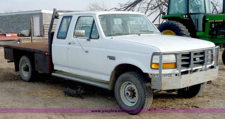 image for item 5124 1992 Ford F-250 extended cab pickup with flatbed and bale spike