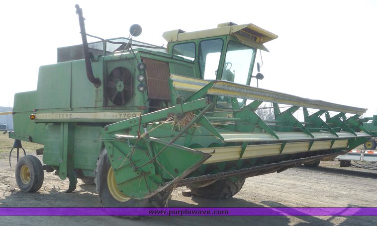 image for item 5134 1973 John Deere 7700 combine with 222 John Deere 22' rigid platform with bat reel