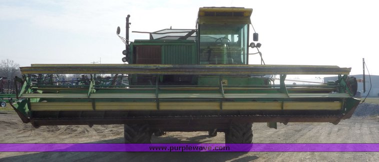 image for item 5134 1973 John Deere 7700 combine with 222 John Deere 22' rigid platform with bat reel