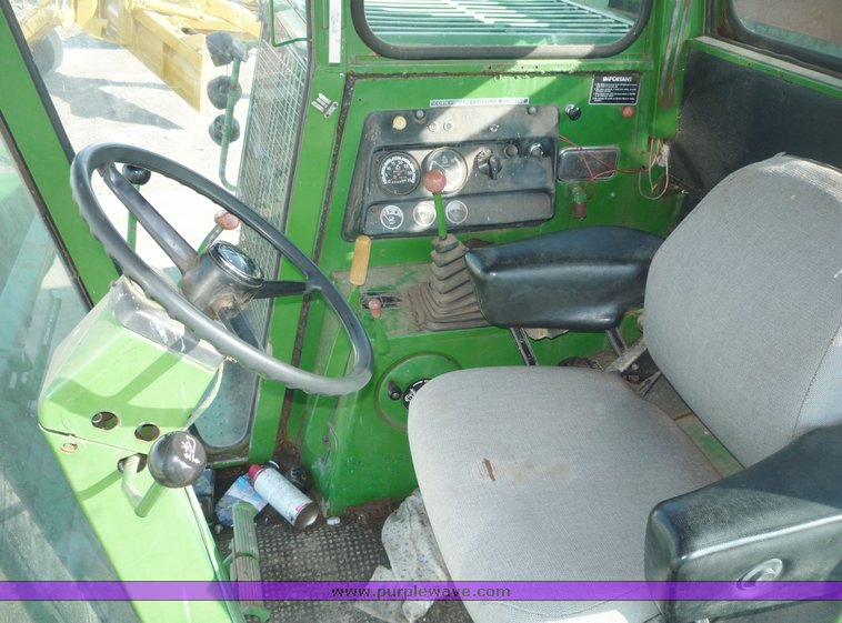 image for item 5134 1973 John Deere 7700 combine with 222 John Deere 22' rigid platform with bat reel