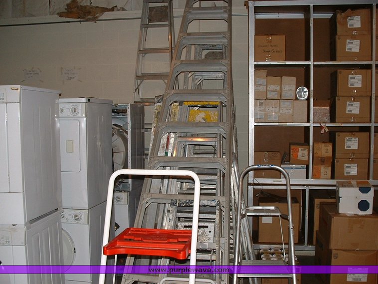 image for item 1005 Assorted ladders, plumbing gate valves and steam radiator valves, electrical boxes, shopping carts, assorted office items, and washer and dryers