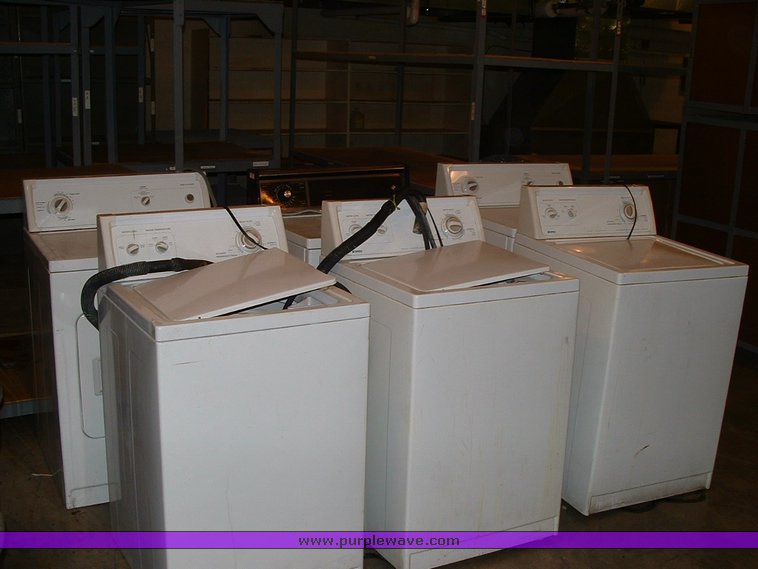 image for item 1005 Assorted ladders, plumbing gate valves and steam radiator valves, electrical boxes, shopping carts, assorted office items, and washer and dryers