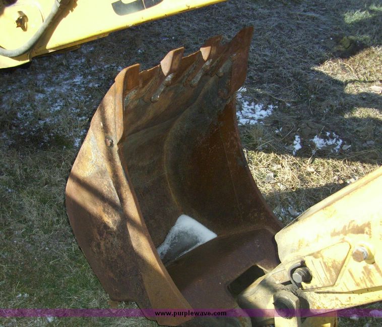 image for item 4608 New Holland 555E backhoe