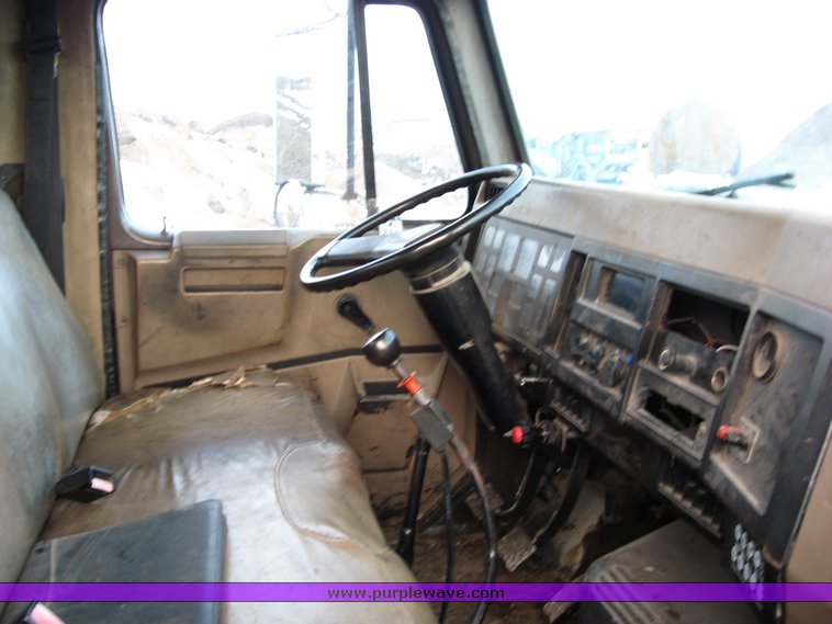 image for item 1023 1991 International Series 4700 flat bed truck with pavement sealer tank