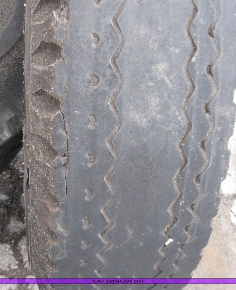 image for item 5606 (3) 10.00-20 tires and wheels