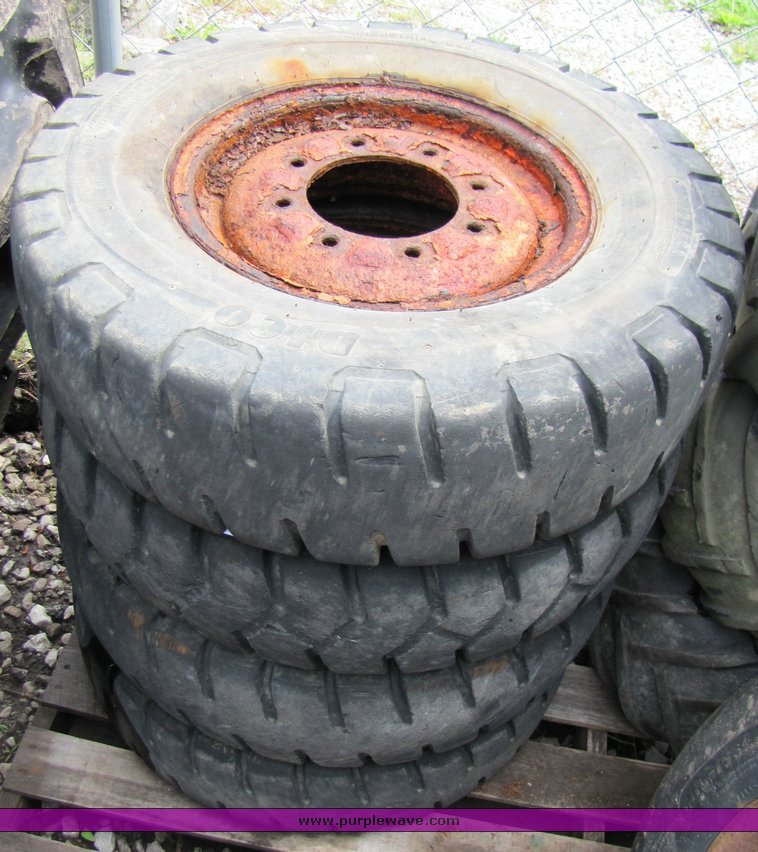 image for item 3338 (4) skidsteer wheels and tires