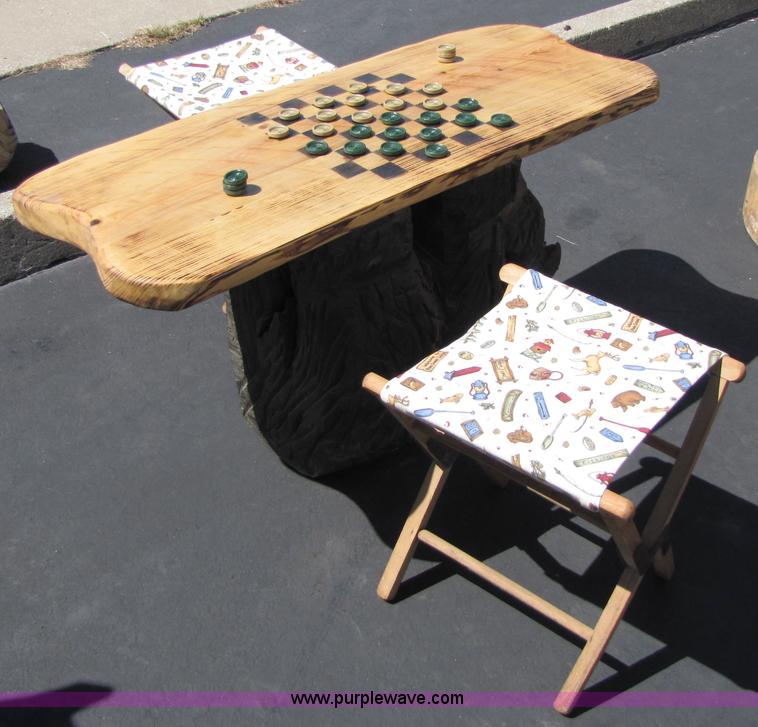 image for item 7194 Bear on its back hold up a checkers table with two stools chainsaw art carving