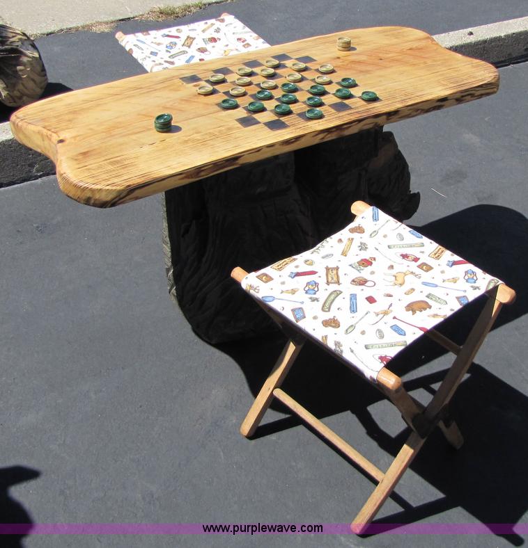 image for item 7194 Bear on its back hold up a checkers table with two stools chainsaw art carving