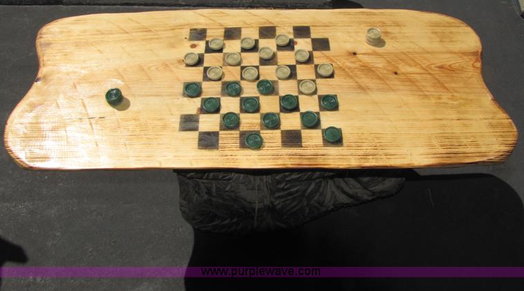 image for item 7194 Bear on its back hold up a checkers table with two stools chainsaw art carving