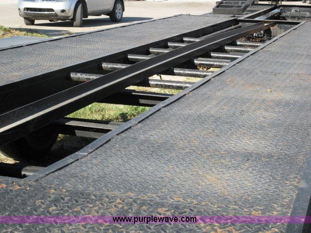 image for item 6235 1997 Hide-A-Bed triple axle gooseneck flatbed trailer