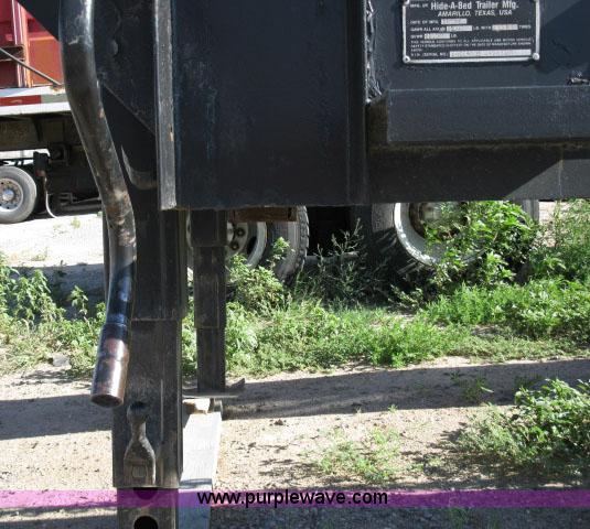 image for item 6235 1997 Hide-A-Bed triple axle gooseneck flatbed trailer