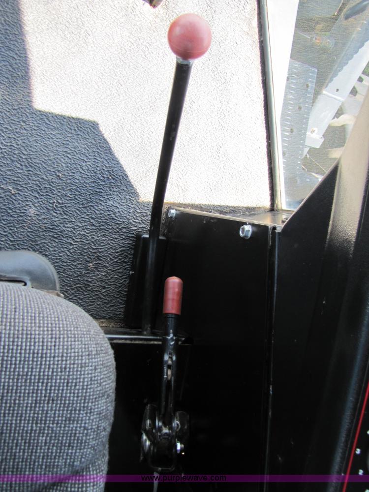 image for item 3142 1998 Mac Don self-propelled windrower with Mac Don 16'auger head