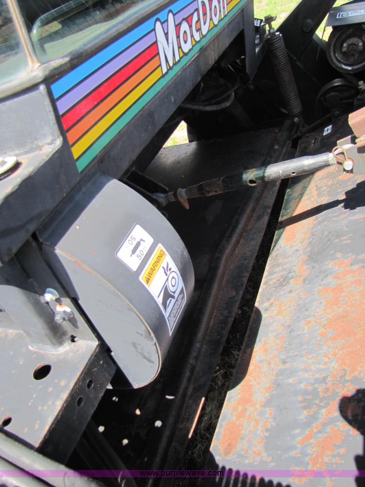 image for item 3142 1998 Mac Don self-propelled windrower with Mac Don 16'auger head