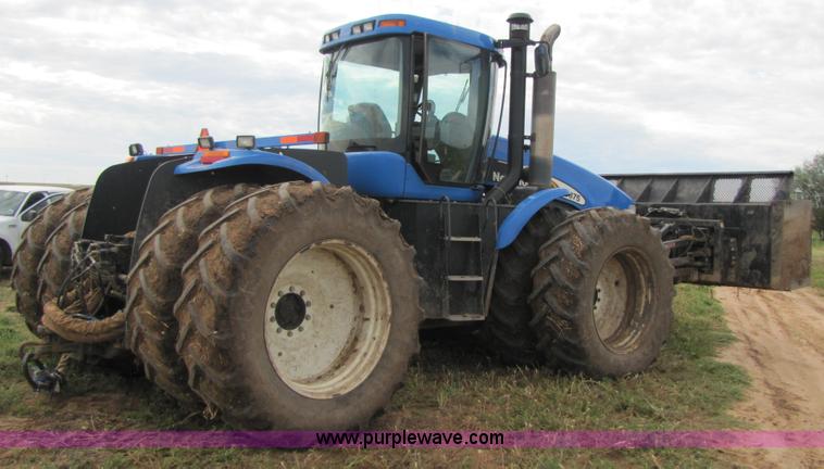 image for item 3143 2006 New Holland TJ375 4WD tractor with Grouser six-way blade