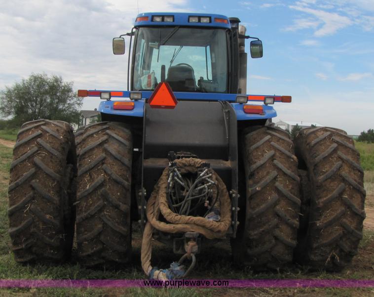 image for item 3143 2006 New Holland TJ375 4WD tractor with Grouser six-way blade
