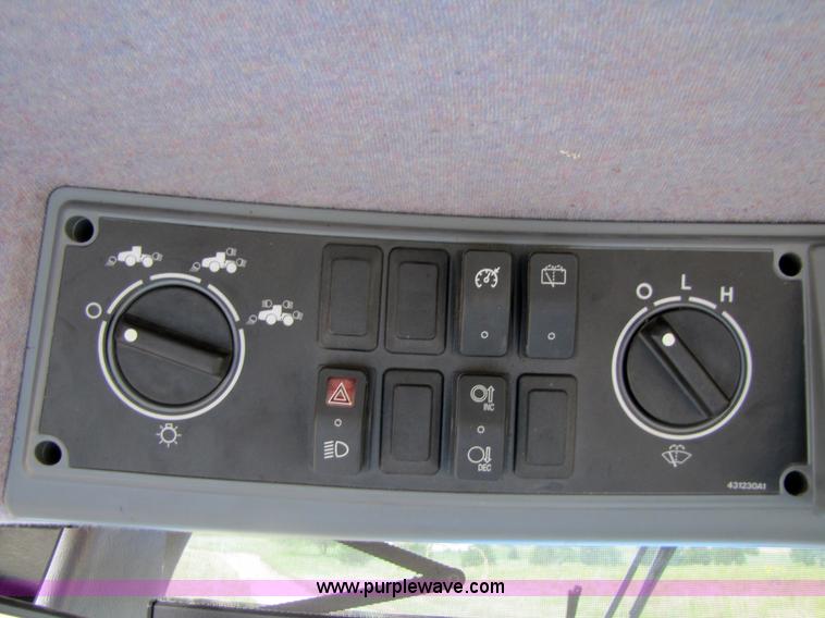 image for item 3143 2006 New Holland TJ375 4WD tractor with Grouser six-way blade