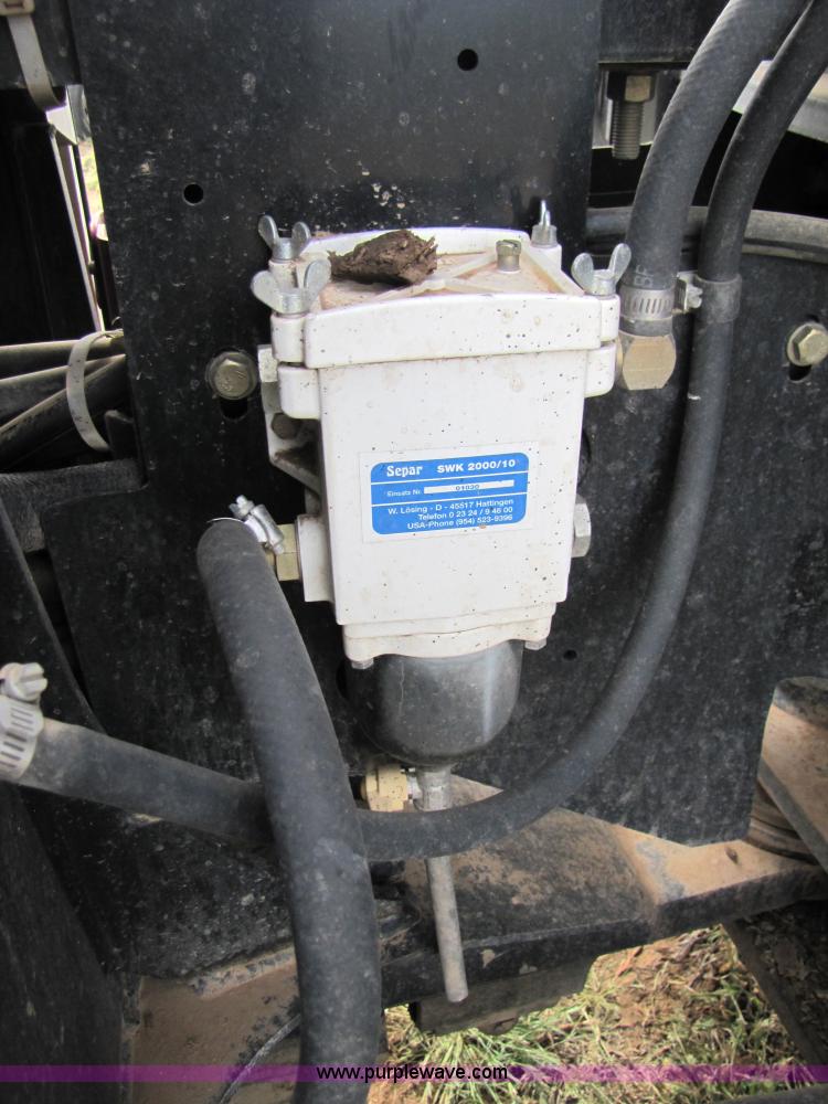 image for item 3143 2006 New Holland TJ375 4WD tractor with Grouser six-way blade