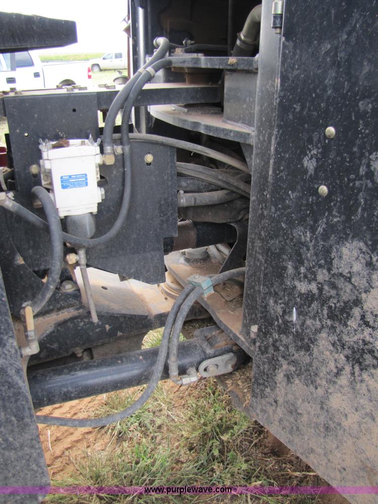 image for item 3143 2006 New Holland TJ375 4WD tractor with Grouser six-way blade