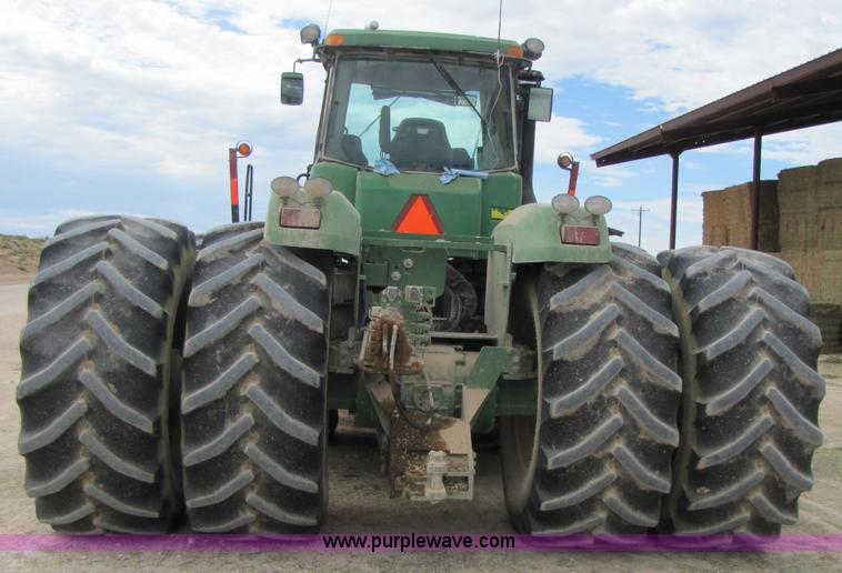 image for item 3144 2004 John Deere 9620 4WD tractor with Grouser 18' two-way blade