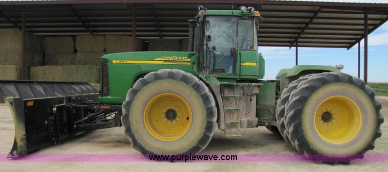 image for item 3144 2004 John Deere 9620 4WD tractor with Grouser 18' two-way blade