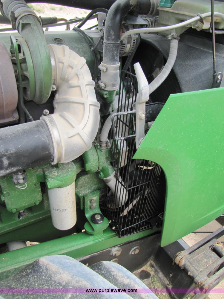 image for item 3144 2004 John Deere 9620 4WD tractor with Grouser 18' two-way blade