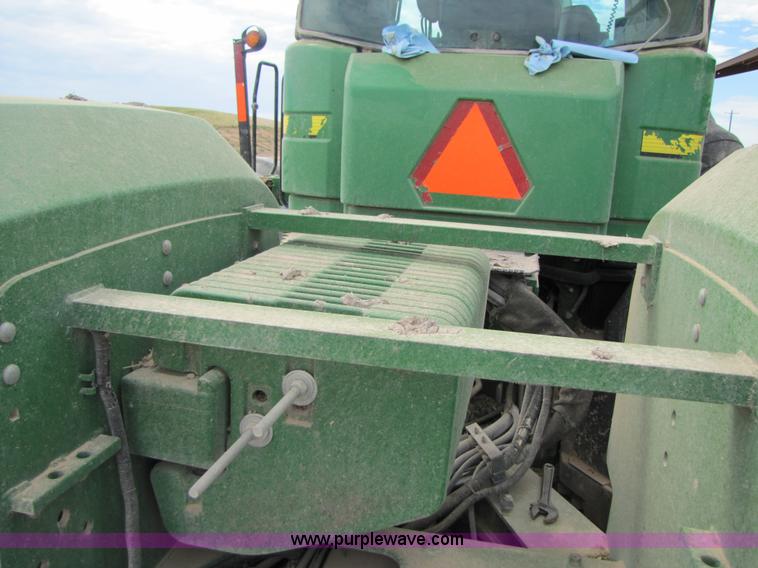 image for item 3144 2004 John Deere 9620 4WD tractor with Grouser 18' two-way blade