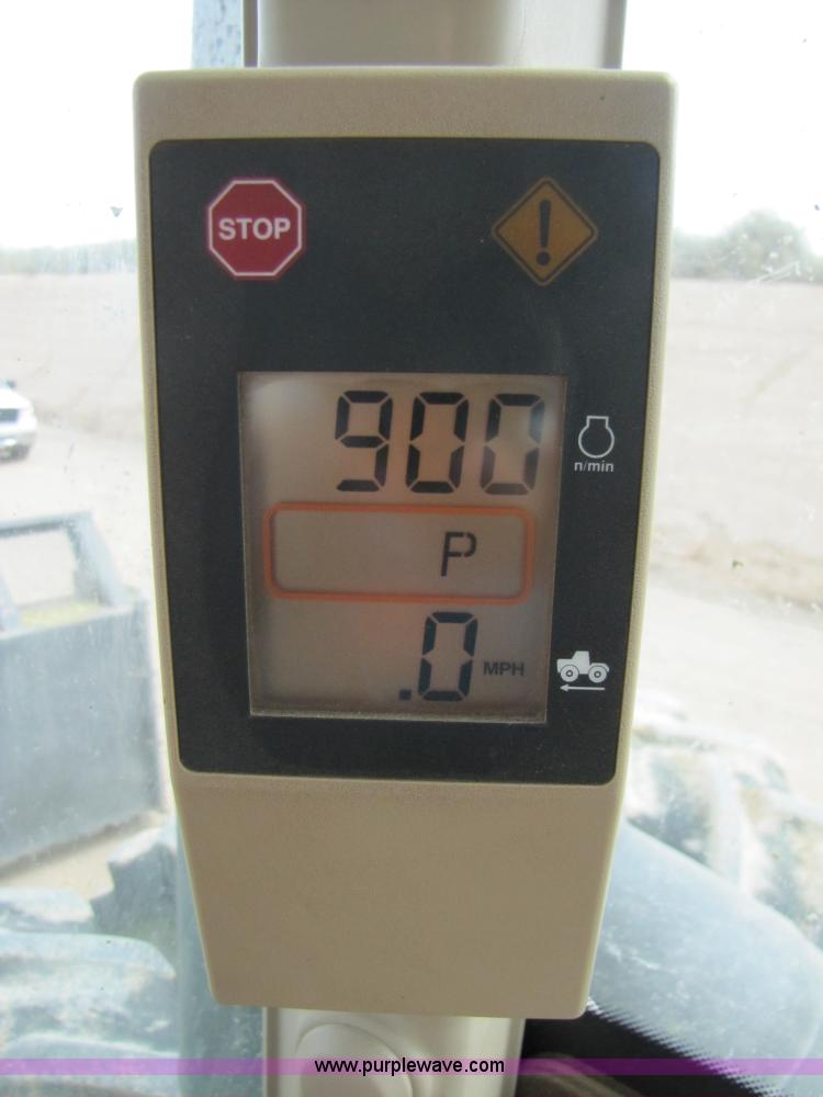 image for item 3145 2005 John Deere 9520 4WD tractor with Grouser two-way blade