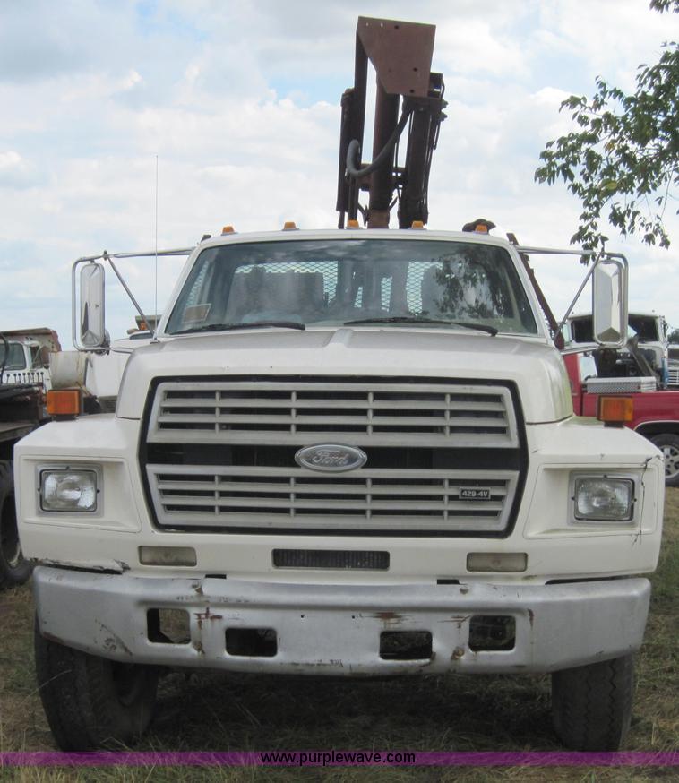 image for item 3179 1988 Ford F800 flatbed truck with hydraulic post driver