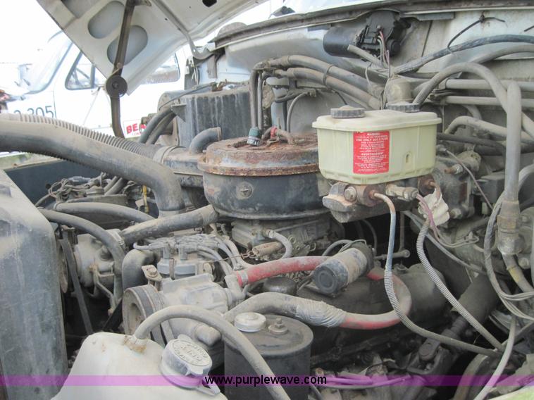 image for item 3179 1988 Ford F800 flatbed truck with hydraulic post driver