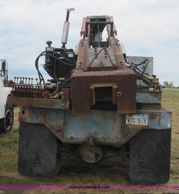 image for item 3180 1989 GMC C7000 flatbed truck with hydraulic post driver