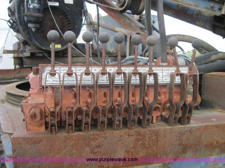 image for item 3180 1989 GMC C7000 flatbed truck with hydraulic post driver