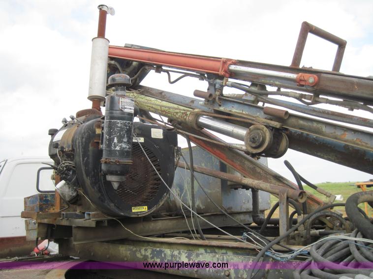 image for item 3180 1989 GMC C7000 flatbed truck with hydraulic post driver